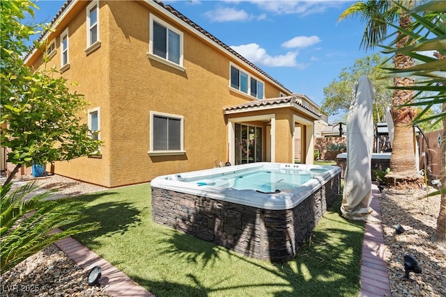 1776 Gentle Brook St, North Las Vegas, NV 89084 - back of house with stucco siding, a hot tub, and a tile roof