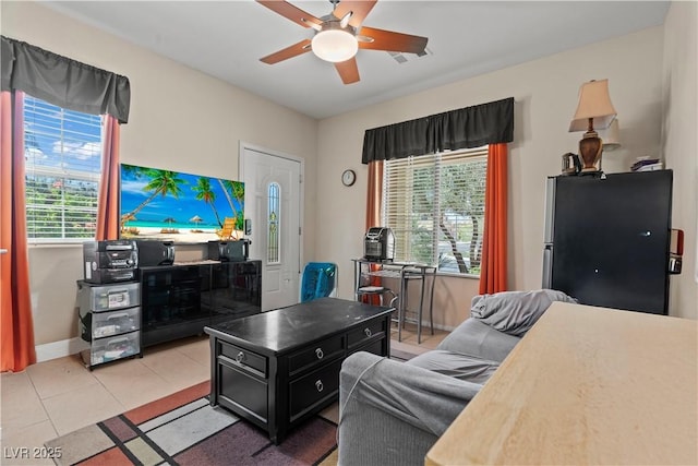 1776 Gentle Brook St, North Las Vegas, NV 89084 - living area with light tile patterned floors, baseboards, a ceiling fan, and visible vents