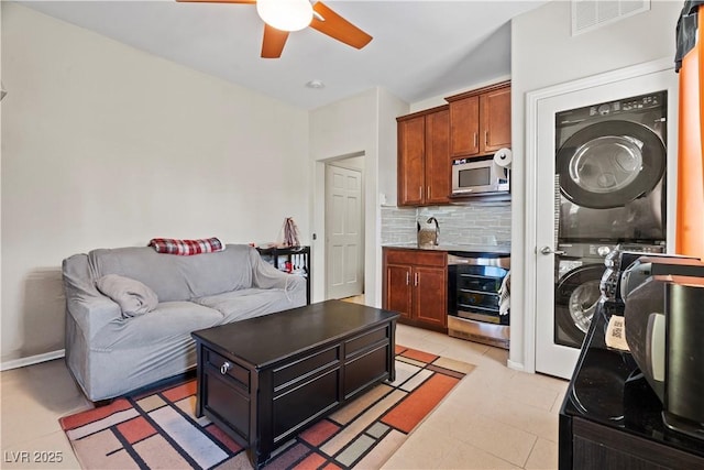 1776 Gentle Brook St, North Las Vegas, NV 89084 - living area featuring stacked washer and clothes dryer, a ceiling fan, visible vents, and light tile patterned floors
