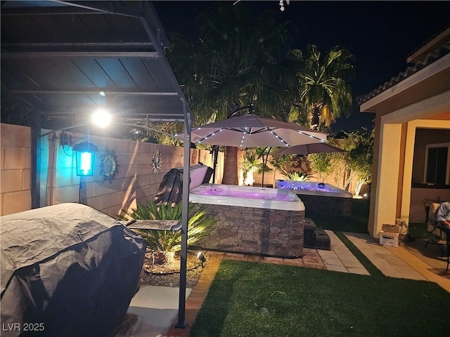 1776 Gentle Brook St, North Las Vegas, NV 89084 - patio at night with fence