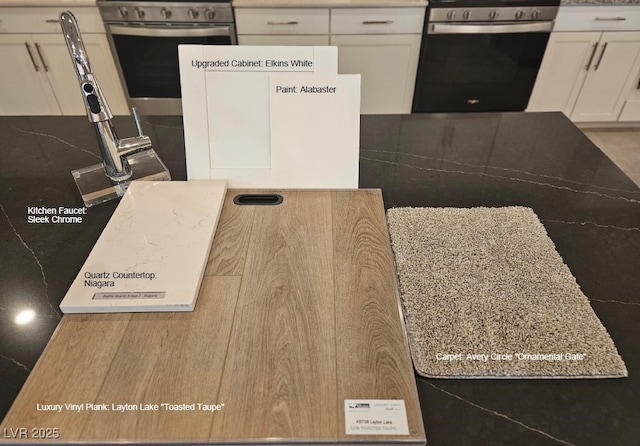 interior space featuring gas stove, white cabinets, and stainless steel range oven