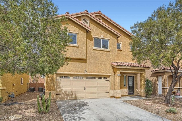 9651 Bouncing Ball St, Las Vegas, NV 89178 - view of front facade featuring a tiled roof, driveway, a garage, stucco siding, and central AC