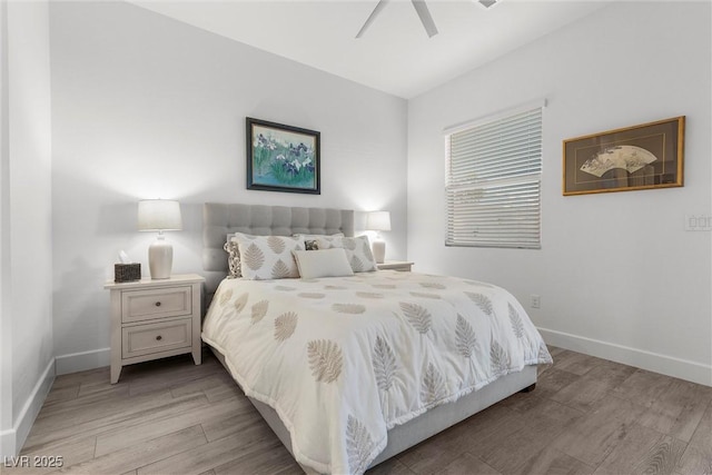 bedroom with light wood-style flooring, ceiling fan, and baseboards