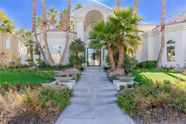8109 Moonstone Cir, Las Vegas, NV 89128 - view of exterior entry featuring stucco siding and a yard