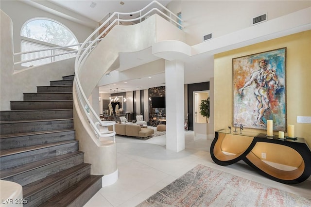 8109 Moonstone Cir, Las Vegas, NV 89128 - stairs with visible vents, tile patterned flooring, and a towering ceiling