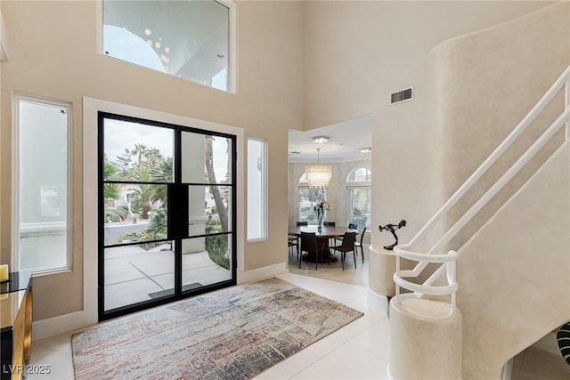 8109 Moonstone Cir, Las Vegas, NV 89128 - tiled entryway featuring a healthy amount of sunlight, a towering ceiling, and visible vents