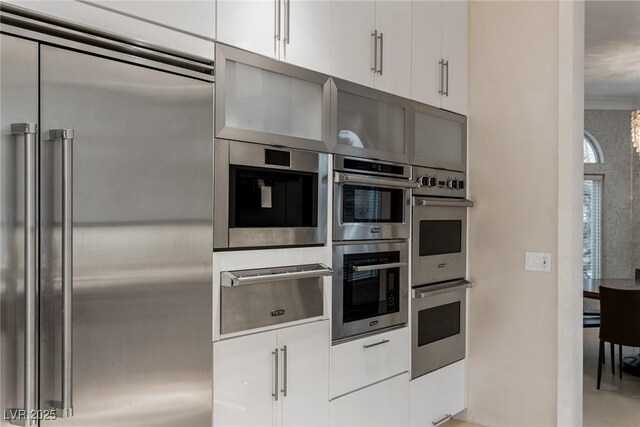 8109 Moonstone Cir, Las Vegas, NV 89128 - kitchen featuring white cabinets, appliances with stainless steel finishes, modern cabinets, and a warming drawer