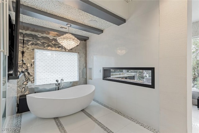 8109 Moonstone Cir, Las Vegas, NV 89128 - full bath with an inviting chandelier, tile patterned flooring, beam ceiling, and a soaking tub