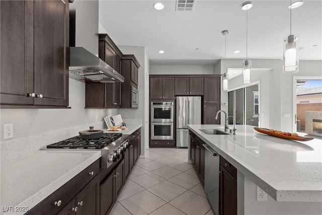 18 Via Tiberina, Henderson, NV 89011 - kitchen with stainless steel appliances, a sink, dark brown cabinetry, pendant lighting, and a spacious island