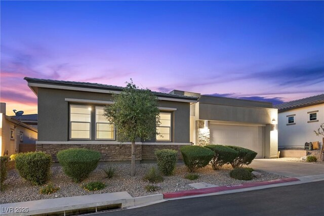18 Via Tiberina, Henderson, NV 89011 - view of front of house featuring stone siding, a garage, and stucco siding