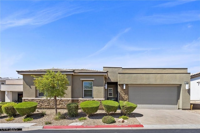 18 Via Tiberina, Henderson, NV 89011 - view of front of home featuring stucco siding, stone siding, and a garage