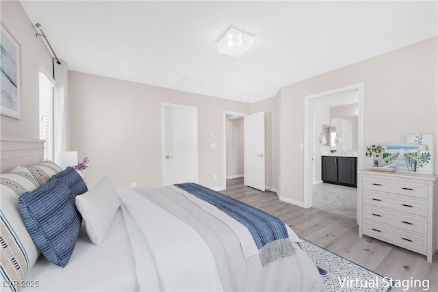 bedroom featuring light wood-type flooring, ensuite bath, and baseboards