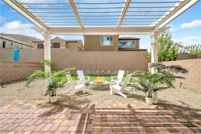 view of patio / terrace featuring a fenced backyard, a pergola, and an outdoor fire pit