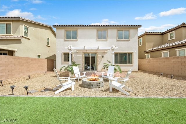 back of property with a pergola, a fenced backyard, a fire pit, and stucco siding
