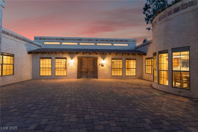6861 E Washington Ave, Las Vegas, NV 89110 - property entrance featuring french doors, stucco siding, a patio area, and a tiled roof