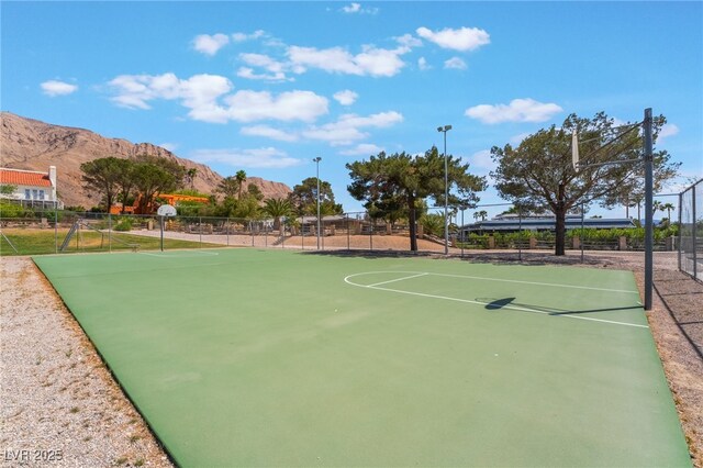 6861 E Washington Ave, Las Vegas, NV 89110 - view of sport court featuring a mountain view, fence, and community basketball court