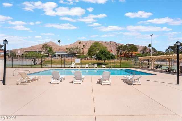 6861 E Washington Ave, Las Vegas, NV 89110 - community pool with a mountain view, a pergola, and fence