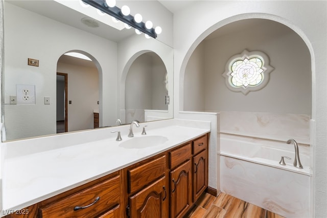 6861 E Washington Ave, Las Vegas, NV 89110 - full bath featuring wood finished floors, vanity, and a garden tub