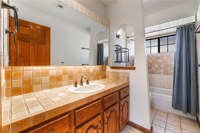 6861 E Washington Ave, Las Vegas, NV 89110 - bathroom featuring tile patterned floors, decorative backsplash, vanity, shower / tub combo, and toilet