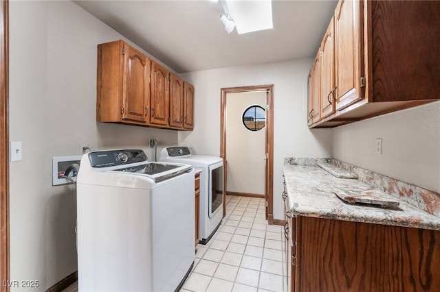 6861 E Washington Ave, Las Vegas, NV 89110 - clothes washing area featuring independent washer and dryer, cabinet space, light tile patterned floors, baseboards, and a skylight