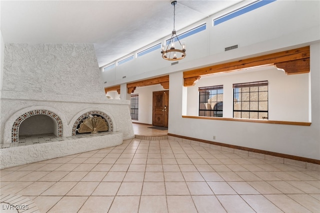 6861 E Washington Ave, Las Vegas, NV 89110 - unfurnished living room with a chandelier, light tile patterned floors, and baseboards