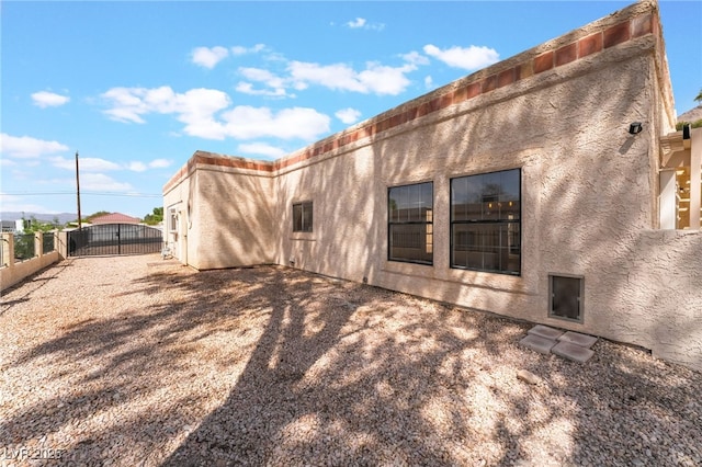 6861 E Washington Ave, Las Vegas, NV 89110 - rear view of house featuring a fenced backyard and stucco siding