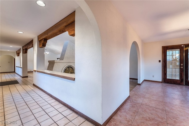 6861 E Washington Ave, Las Vegas, NV 89110 - corridor featuring arched walkways, light tile patterned floors, recessed lighting, baseboards, and beamed ceiling