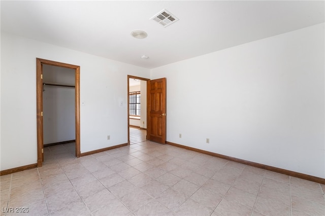 6861 E Washington Ave, Las Vegas, NV 89110 - unfurnished bedroom with baseboards, a spacious closet, and a closet
