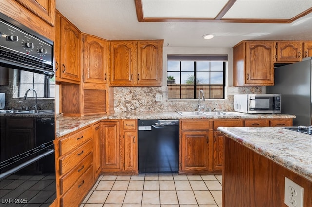 6861 E Washington Ave, Las Vegas, NV 89110 - kitchen with black appliances, a sink, brown cabinets, light tile patterned flooring, and recessed lighting