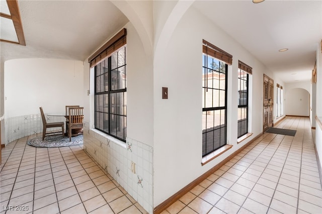 6861 E Washington Ave, Las Vegas, NV 89110 - hall featuring arched walkways and light tile patterned floors