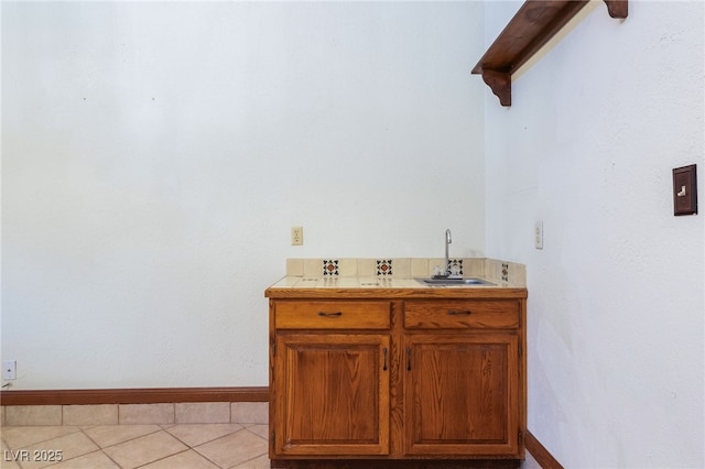 6861 E Washington Ave, Las Vegas, NV 89110 - bathroom featuring a sink, baseboards, and tile patterned floors