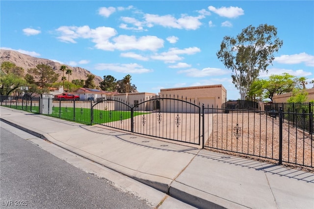 6861 E Washington Ave, Las Vegas, NV 89110 - view of asphalt road featuring sidewalks, a mountain view, and curbs