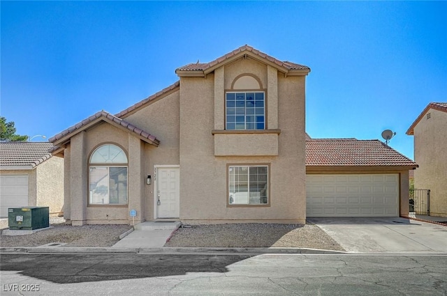view of front of property with driveway, a tile roof, a garage, and stucco siding