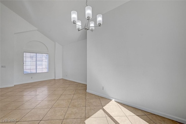 spare room featuring light tile patterned floors, baseboards, a notable chandelier, and lofted ceiling