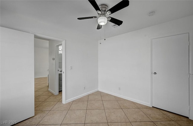 unfurnished bedroom featuring light tile patterned flooring, baseboards, a ceiling fan, and visible vents