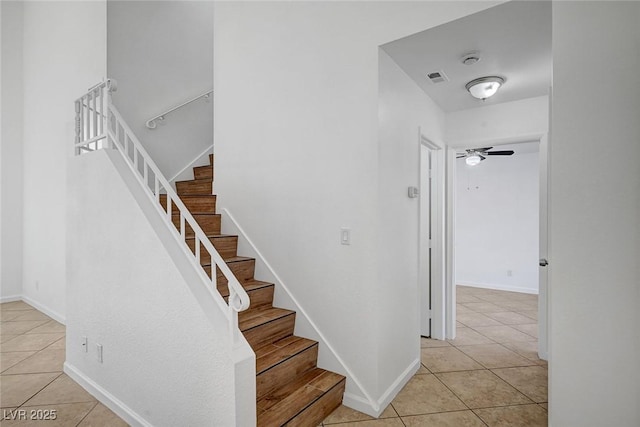 stairs featuring ceiling fan, baseboards, tile patterned flooring, and visible vents