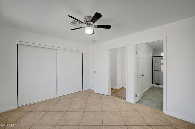 unfurnished bedroom featuring a closet, ceiling fan, tile patterned flooring, and visible vents