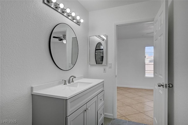 bathroom featuring tile patterned flooring, vanity, and baseboards