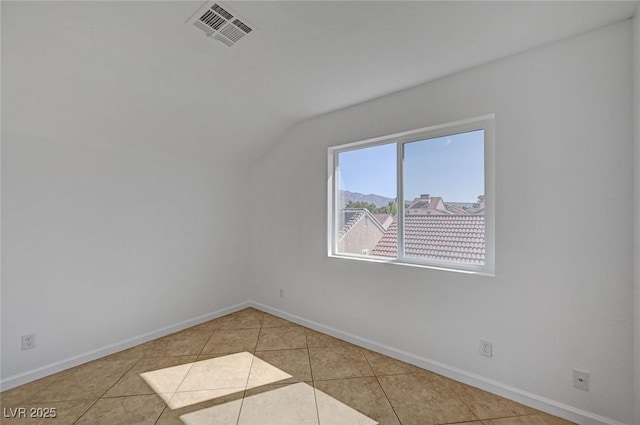 bonus room featuring visible vents, tile patterned floors, vaulted ceiling, and baseboards