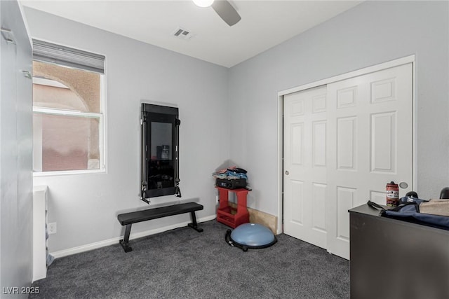 interior space with baseboards, visible vents, and a ceiling fan