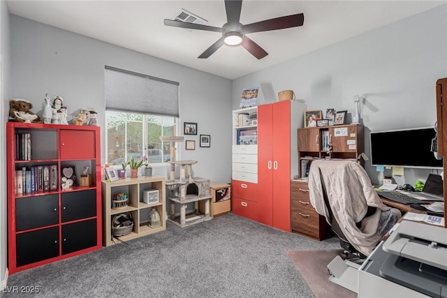 carpeted office space with a ceiling fan and visible vents