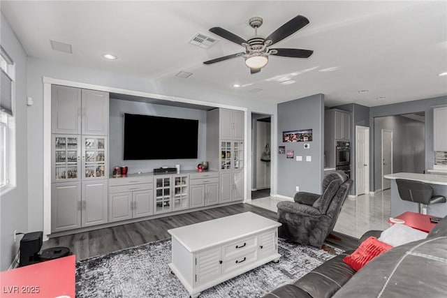 living area with visible vents, recessed lighting, baseboards, light wood-type flooring, and a ceiling fan