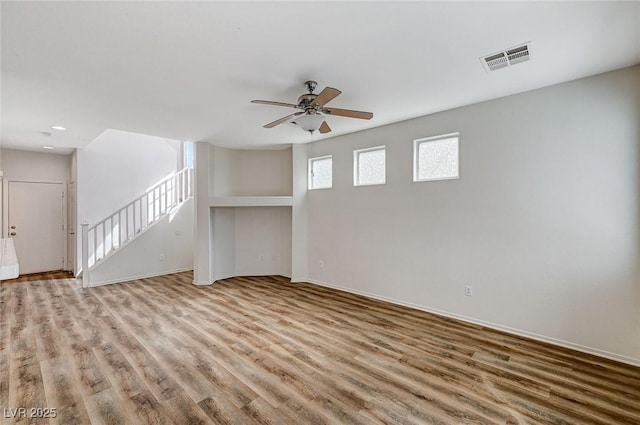 unfurnished living room featuring wood finished floors, ceiling fan, baseboards, and recessed lighting