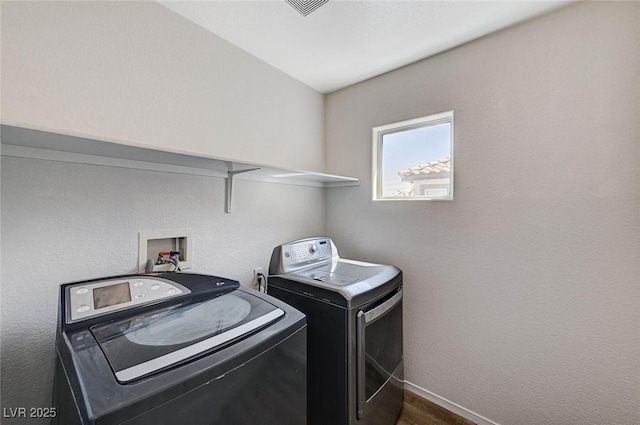 laundry area featuring independent washer and dryer and baseboards