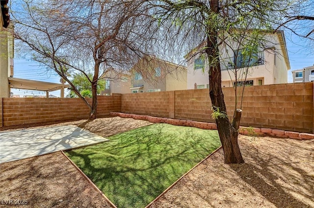 fenced backyard with a patio area