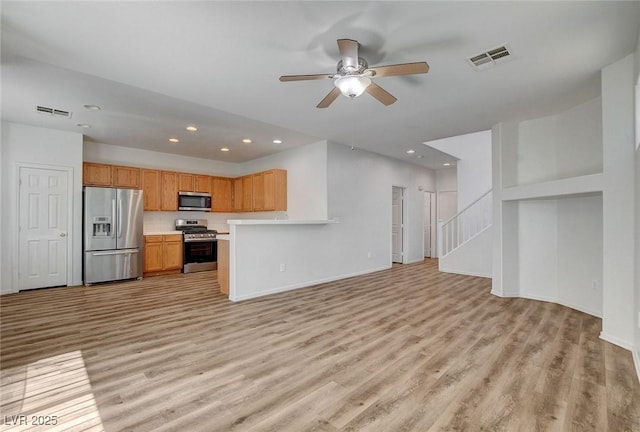 unfurnished living room featuring light wood-style floors, recessed lighting, a ceiling fan, baseboards, and stairway