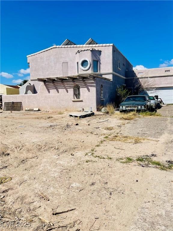 back of house featuring stucco siding