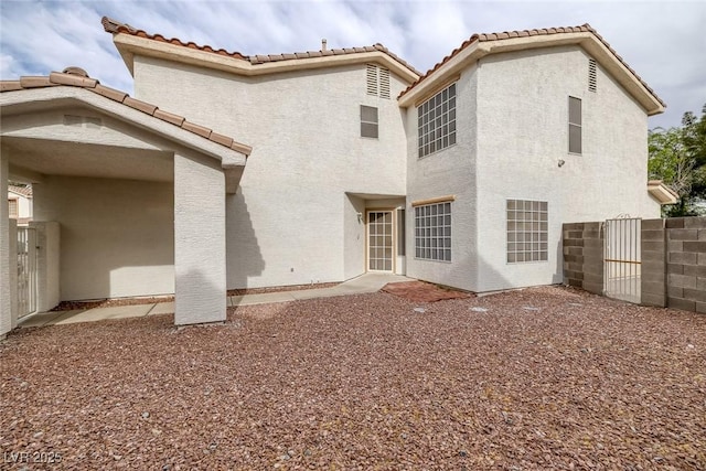 8005 Exploration Ave, Las Vegas, NV 89131 - back of property featuring fence, a tiled roof, and stucco siding