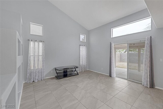 8005 Exploration Ave, Las Vegas, NV 89131 - unfurnished room featuring high vaulted ceiling, baseboards, and light tile patterned flooring