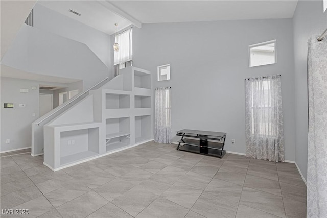 8005 Exploration Ave, Las Vegas, NV 89131 - unfurnished living room featuring plenty of natural light, visible vents, high vaulted ceiling, and built in features